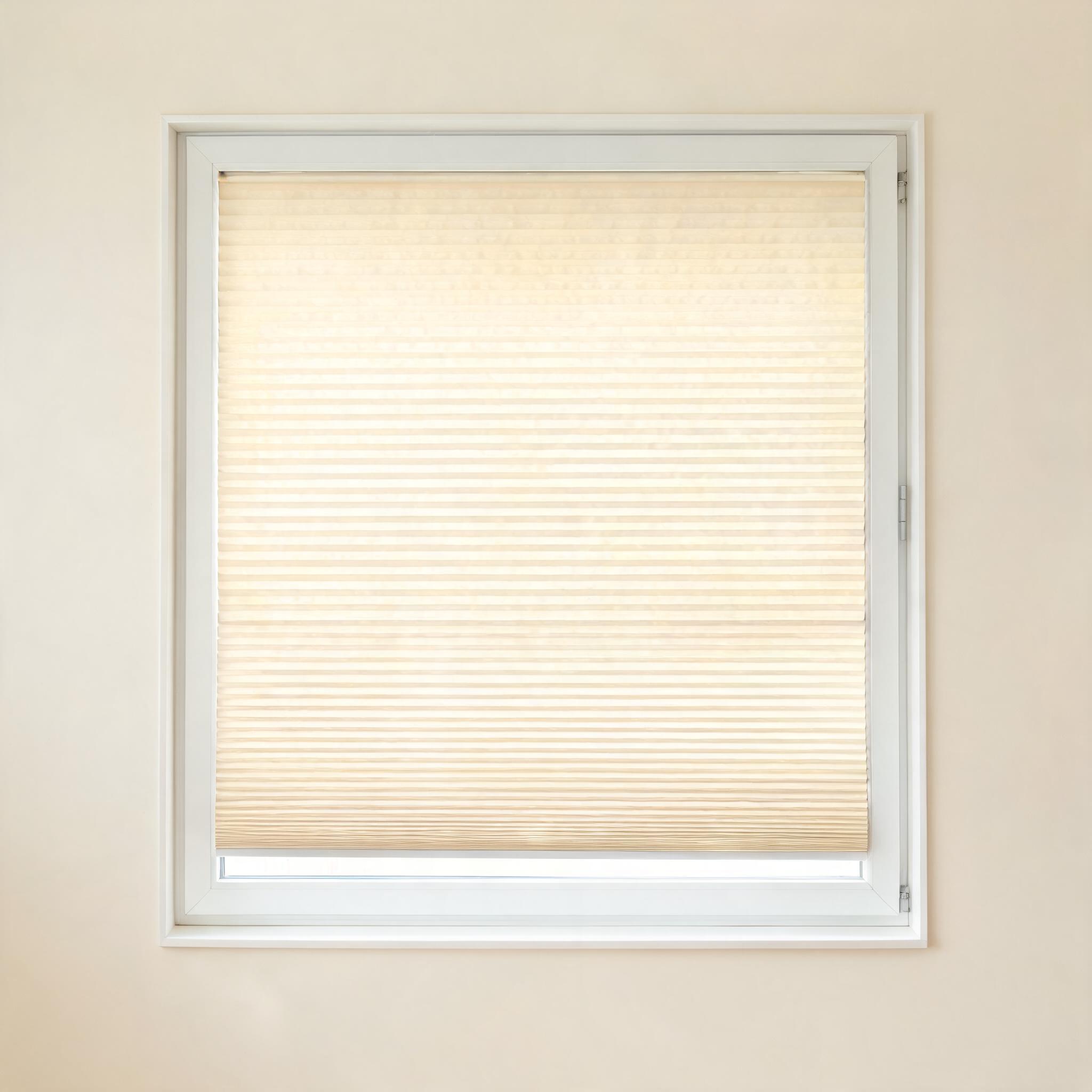 Honeycomb cellular shade in warm cream.